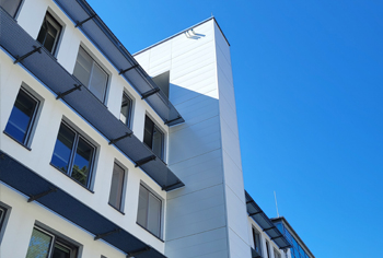 Cladding of ventilation tower with white aluminum Dangel panels